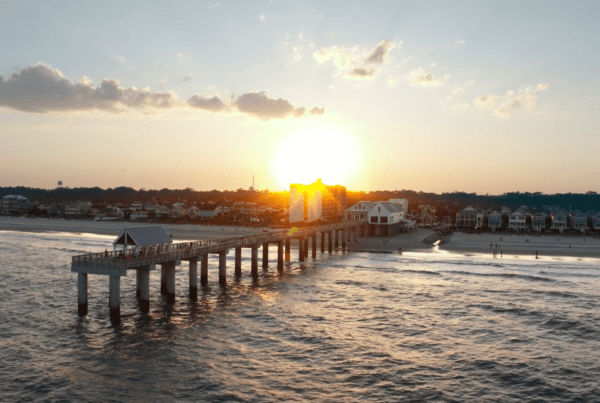 Hotel drone video content capturing sunset over Surfside Beach pier and Surfside Oceanfront Hotel in South Carolina